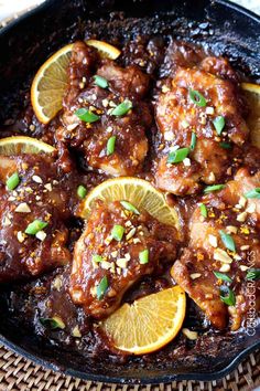 chicken with oranges and sesame seeds in a skillet