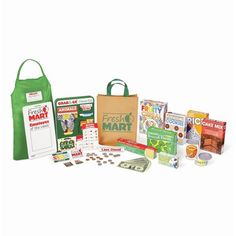 an assortment of children's books and games in a green tote bag with the contents