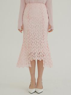 The DUL Sentimental Skirt in Baby Pink is a sophisticated mermaid-style lace skirt featuring REORG's signature pattern, designed to enhance the feminine silhouette with its body-contouring fit. The tightly woven lace fabric and strategic design elements work together to create an elongating effect on the legs, while the asymmetric hemline adds a contemporary twist. This versatile piece, available in sizes S through L and crafted from 100% polyester, transitions seamlessly from elegant occasions Pink Knee-length Bottoms For Spring, Elegant Knee-length Pink Bottoms, Elegant Pink Skirted Bottoms, Pink Asymmetrical Skirt For Spring, Pink Knee-length Party Bottoms, Feminine Pink Knee-length Bottoms, Elegant Pink Knee-length Bottoms, Feminine Pink Party Bottoms, Fitted Pink Skirt For Spring