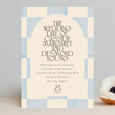 a wedding card with a donut on the table next to it and an envelope