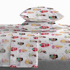 disney princess sheets and pillowcases are stacked on top of each other in this bedding set