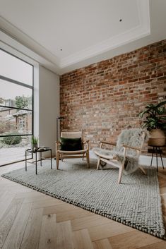 a living room filled with furniture and a brick wall