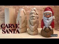 three carved wooden santa figurines sitting next to each other