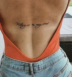 a woman with a tattoo on her back saying, may is my year written in cursive writing