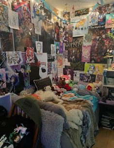 a room with posters and stuffed animals on the wall, all over the bed area