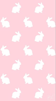 a pink background with white rabbits on it