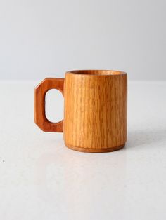 a wooden cup sitting on top of a white table