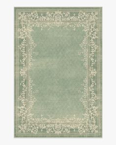 a green rug with an ornate border