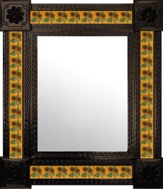 a decorative mirror with an ornate border around the edges and flowers painted on the sides