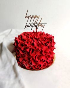 a birthday cake with red ruffles and a happy birthday candle on top that says happy birthday