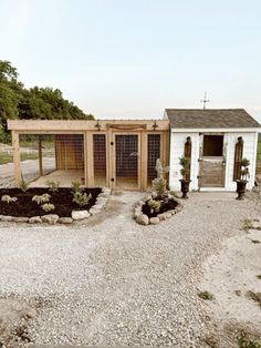 an outdoor chicken coop with gravel and rocks