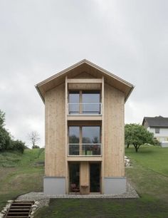 a small wooden house sitting on top of a lush green field