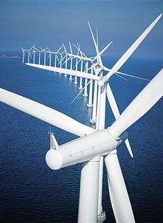 an aerial view of a wind farm in the ocean