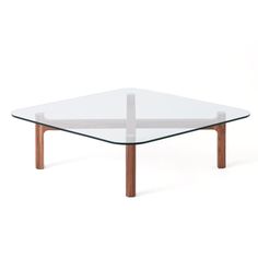 a glass table with wooden legs on a white background