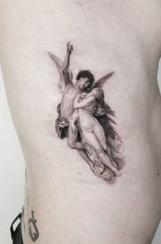 a tattoo on the back of a man's stomach with two cherubs