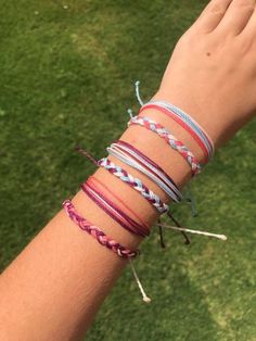 a person wearing several different bracelets on their arm