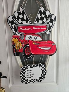 a door sign with cars painted on it