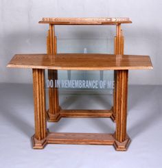 a wooden table with a glass shelf on the top that says do it remembrance of me