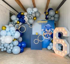 a room filled with balloons and lights in the shape of sonic's birthday decorations