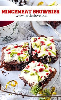 chocolate brownies with white frosting and pomegranates on top, sitting on a glass plate