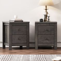 two nightstands sitting next to each other on top of a wooden floor in front of a white wall