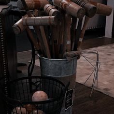 a bucket filled with lots of different types of wooden utensils