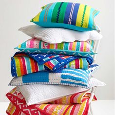 colorful pillows stacked on top of each other