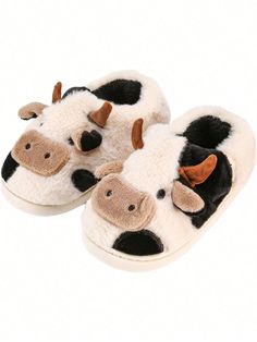 a pair of slippers with cows on them