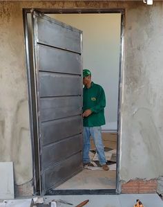 a man standing in front of a metal door