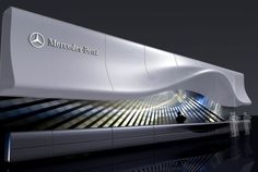 the mercedes benz logo is displayed at an event in front of a large white structure