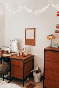 a bedroom with two desks, a chair and pictures on the wall above them