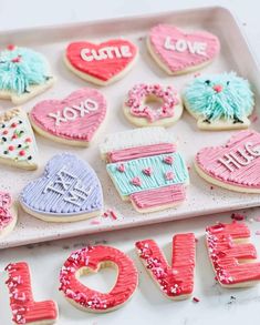 decorated cookies that spell out love on a tray