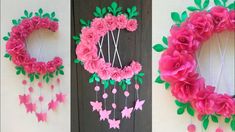 three pictures of pink flowers and butterflies hanging from the side of a door with green leaves