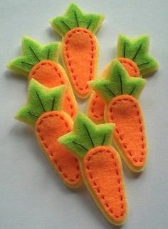 three felt carrots sitting on top of each other