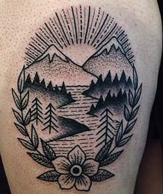 a black and white tattoo with mountains, trees and flowers on the side of a woman's thigh