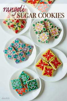 four plates with decorated cookies on them sitting next to each other in different shapes and sizes