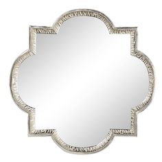 a mirror with an ornate design on the front and back side, in silver color