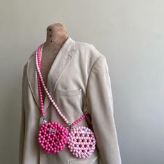 a mannequin wearing a pink beaded purse