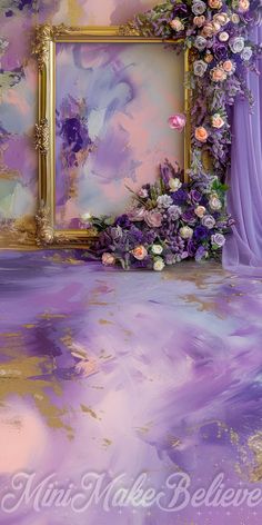 an artistic painting with purple and pink flowers on the floor next to a gold frame