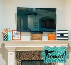 a fireplace mantel with a tv above it and some decorations on the mantles