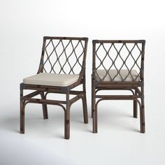 two wooden chairs with white cushions on each side and one chair in the middle, against a white background