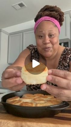 a woman is holding up a piece of bread