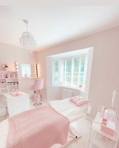 a pink bedroom with white furniture and accessories