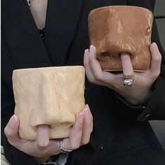 two hands holding different types of purses in each other's palms and fingers