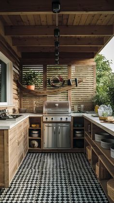 an outdoor kitchen with black and white checkered flooring