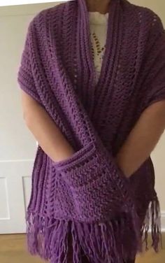 a woman wearing a purple knitted shawl