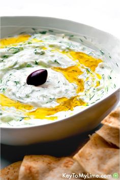 a white bowl filled with dip and crackers