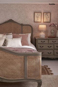 a bedroom with wicker furniture and pink walls