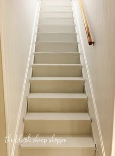 the stairs leading up to the bedroom are painted white and have no carpet on them