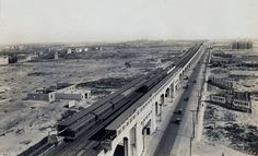 an old black and white photo of a train on the tracks